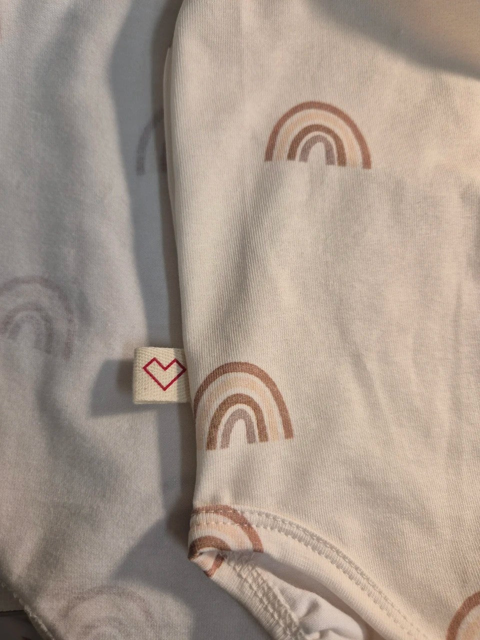 Close-up of skin-friendly breathable fabric on Karloova baby bodysuit - Rainbow
