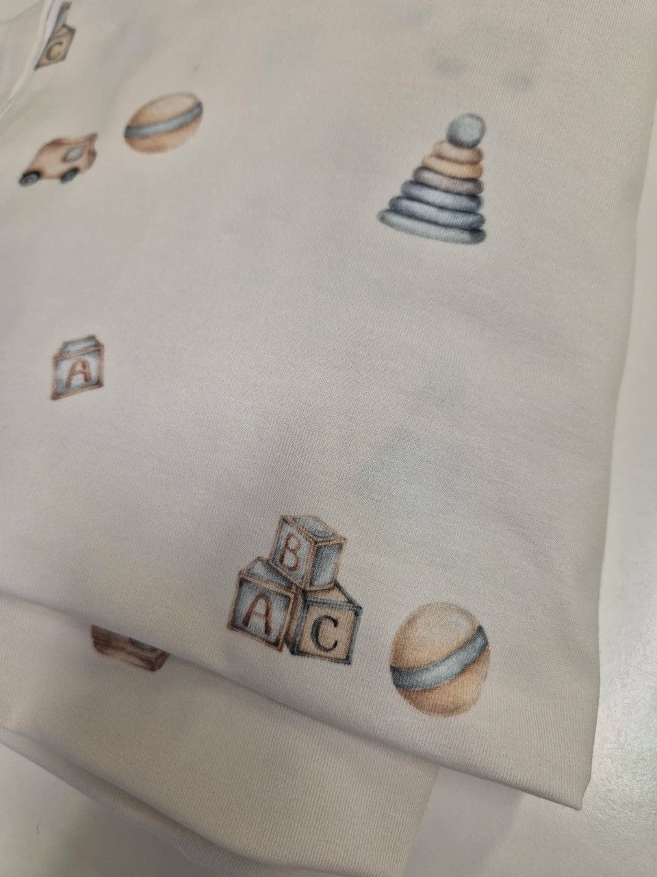 Close-up of skin-friendly breathable fabric on Karloova baby bodysuit - Toys
