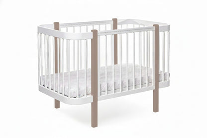 Ergonomic newborn mattress fitted inside the two-tone cappuccino KOTTO crib