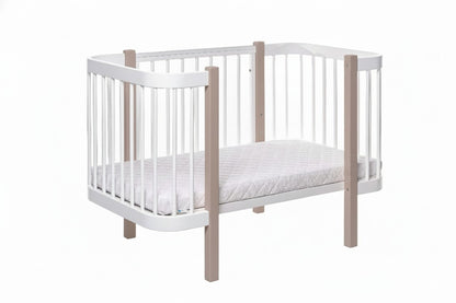 Safe sleep nursery setup featuring a cappuccino wooden bed and firm mattress