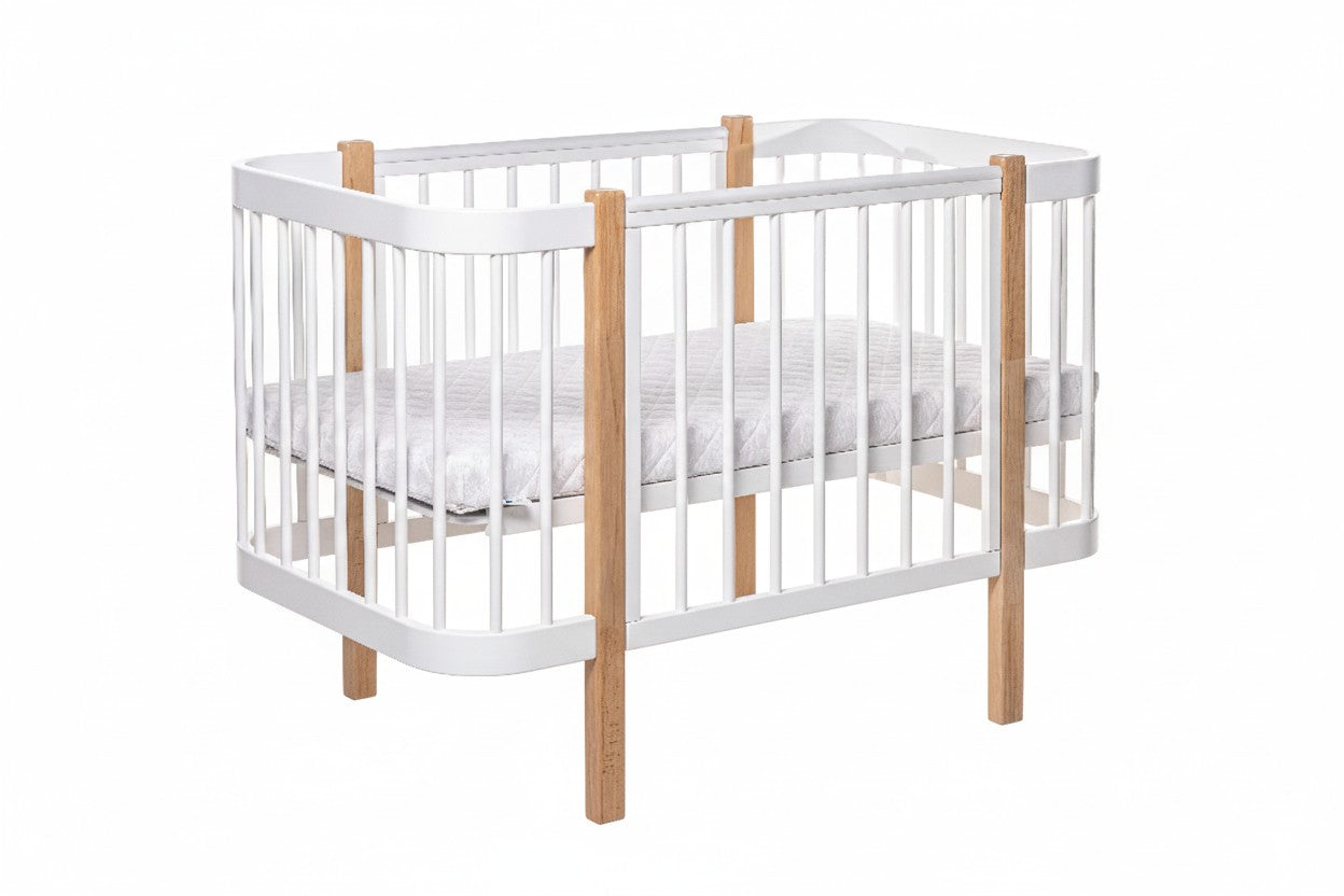 Front view of the two-tone natural oak and white standard nursery cot