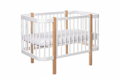 Front view of the two-tone natural oak and white standard nursery cot