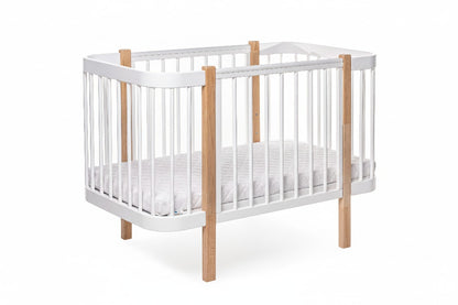 Safe sleep nursery setup featuring a natural wood bed and firm mattress