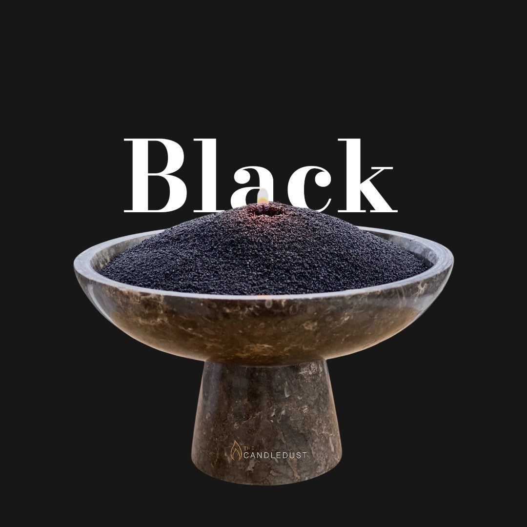 Black text on a matching dark background with a glass vase full of unlit pearled candle sand in the foreground