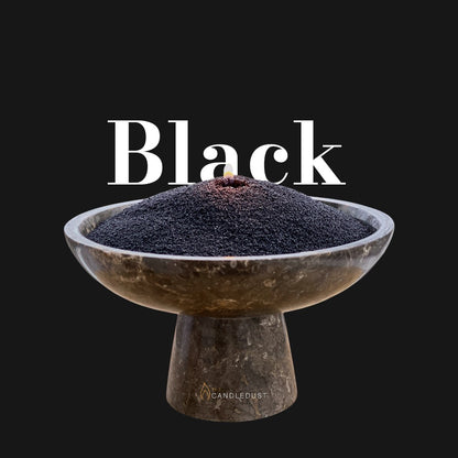 Black text on a matching dark background with a glass vase full of unlit pearled candle sand in the foreground