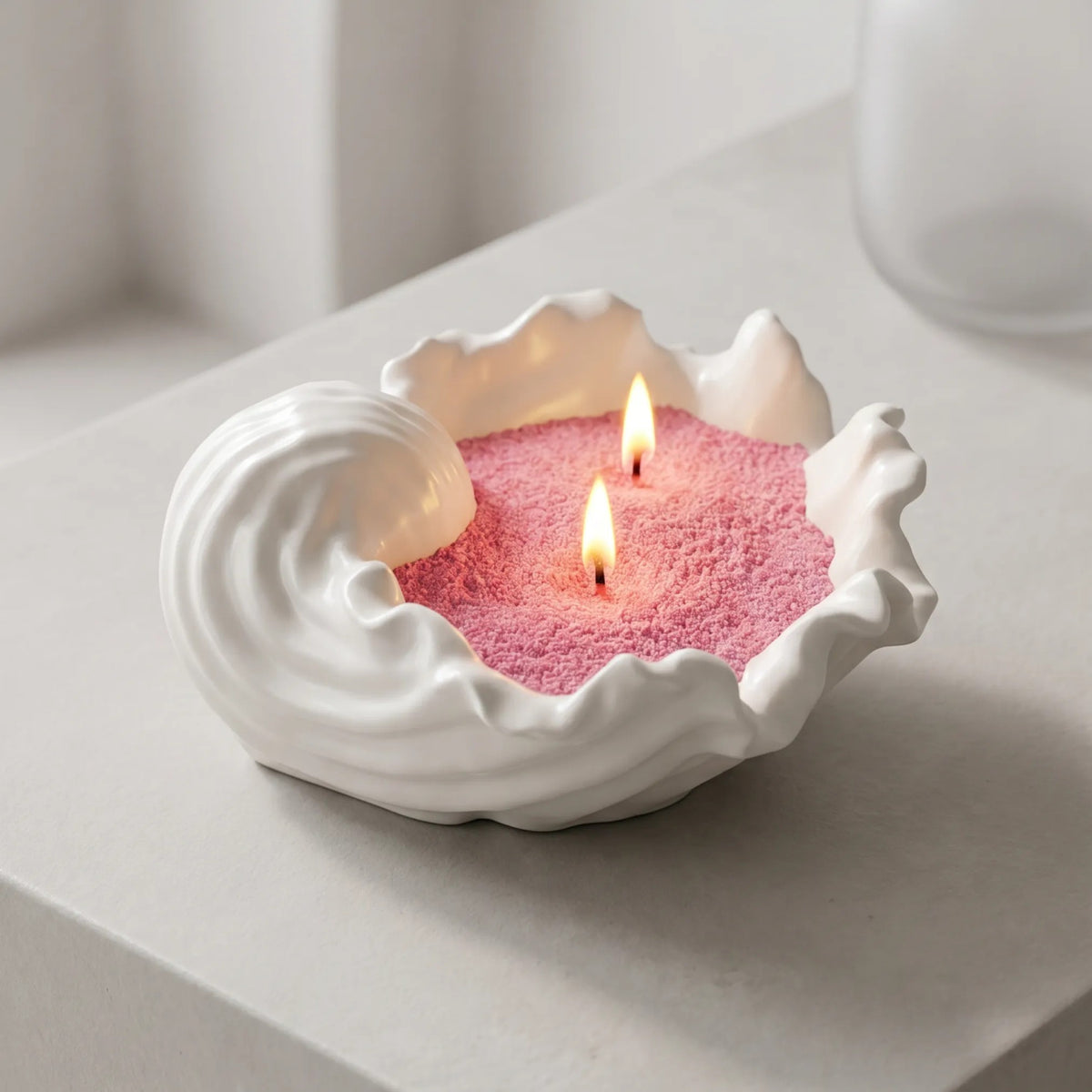 Elegant vase filled with Blush Vintage pearled candle sand and lit cotton wicks resting on a refined clean countertop