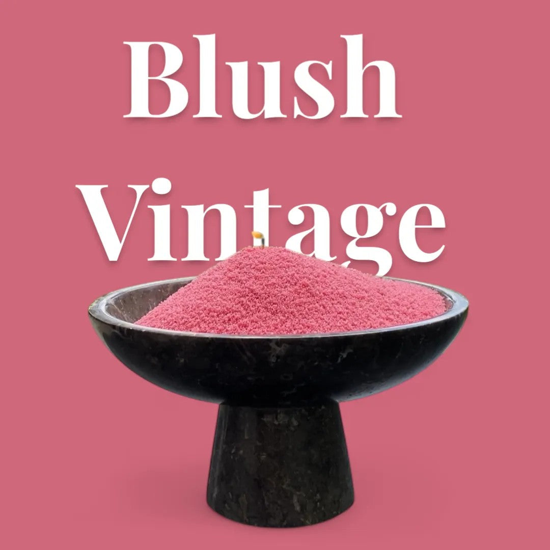 Blush Vintage text on a blush pink background with a glass vase of unlit pearled candle sand in the foreground