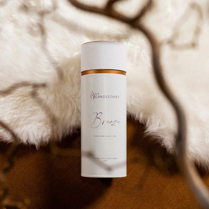 Candledust Breeze scented pearled candle sand in a 650g cylindrical packaging tube on a elegant carpet