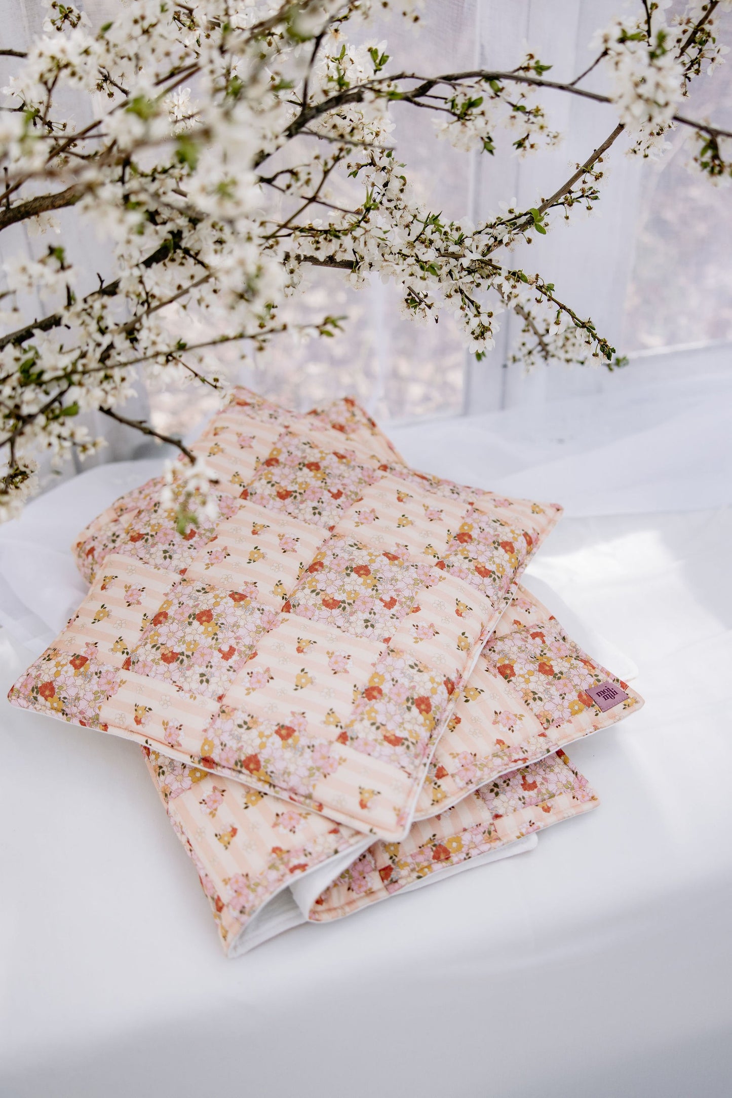 Spring Garden pastel floral patchwork design on a small quilted blanket