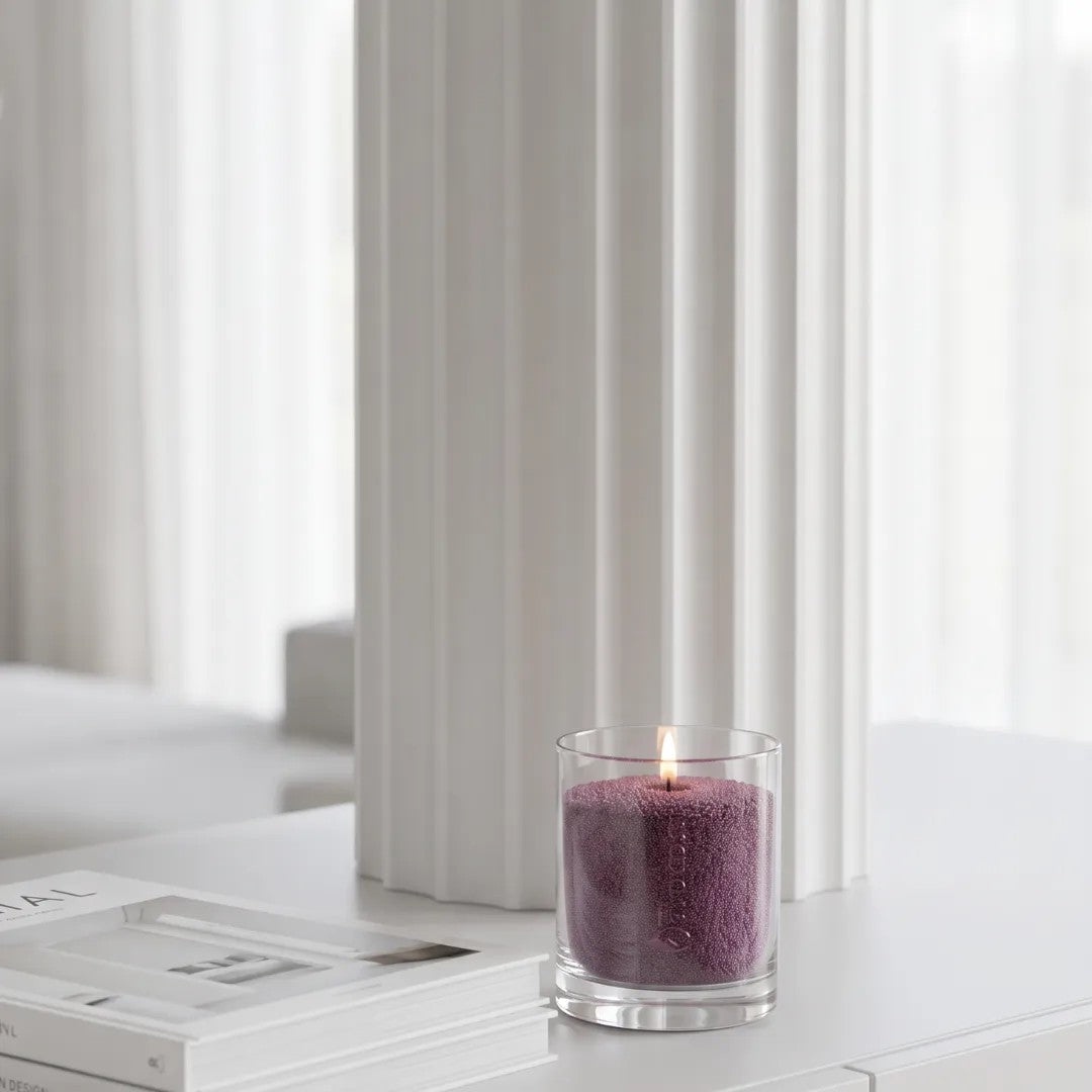 Elegant atmosphere with a Dark Lilac pearled glass candle burning cleanly on a white table