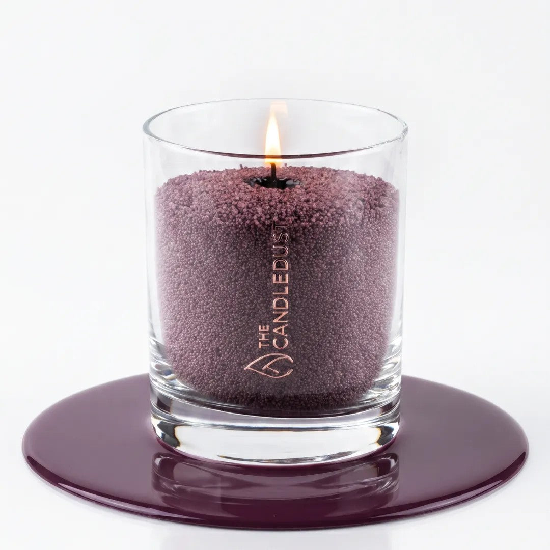 Close-up texture of natural plant-based Dark Lilac purple pearled candle wax granules inside a glass container