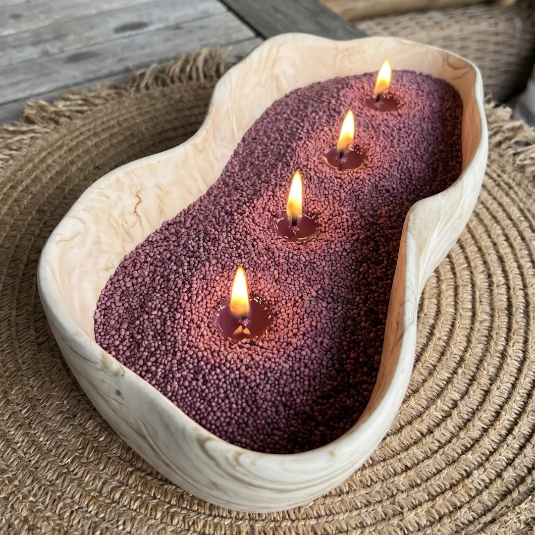 Large decorative vase filled with Dark Lilac pearled candle sand and multiple lit cotton wicks burning cleanly