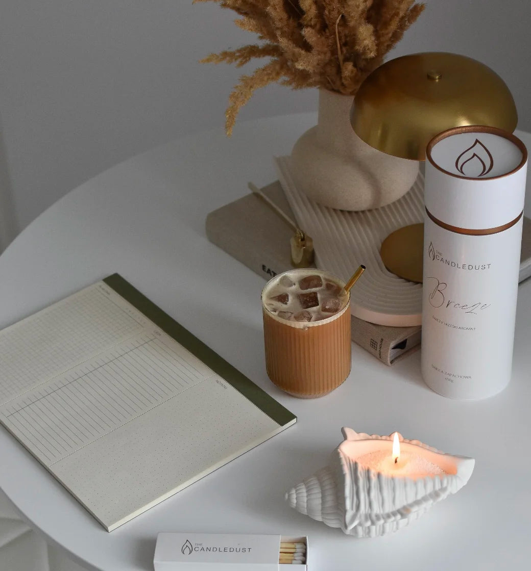 Candledust Dark Honey candle sand tube and lit pearled glass candle on a wooden dining table
