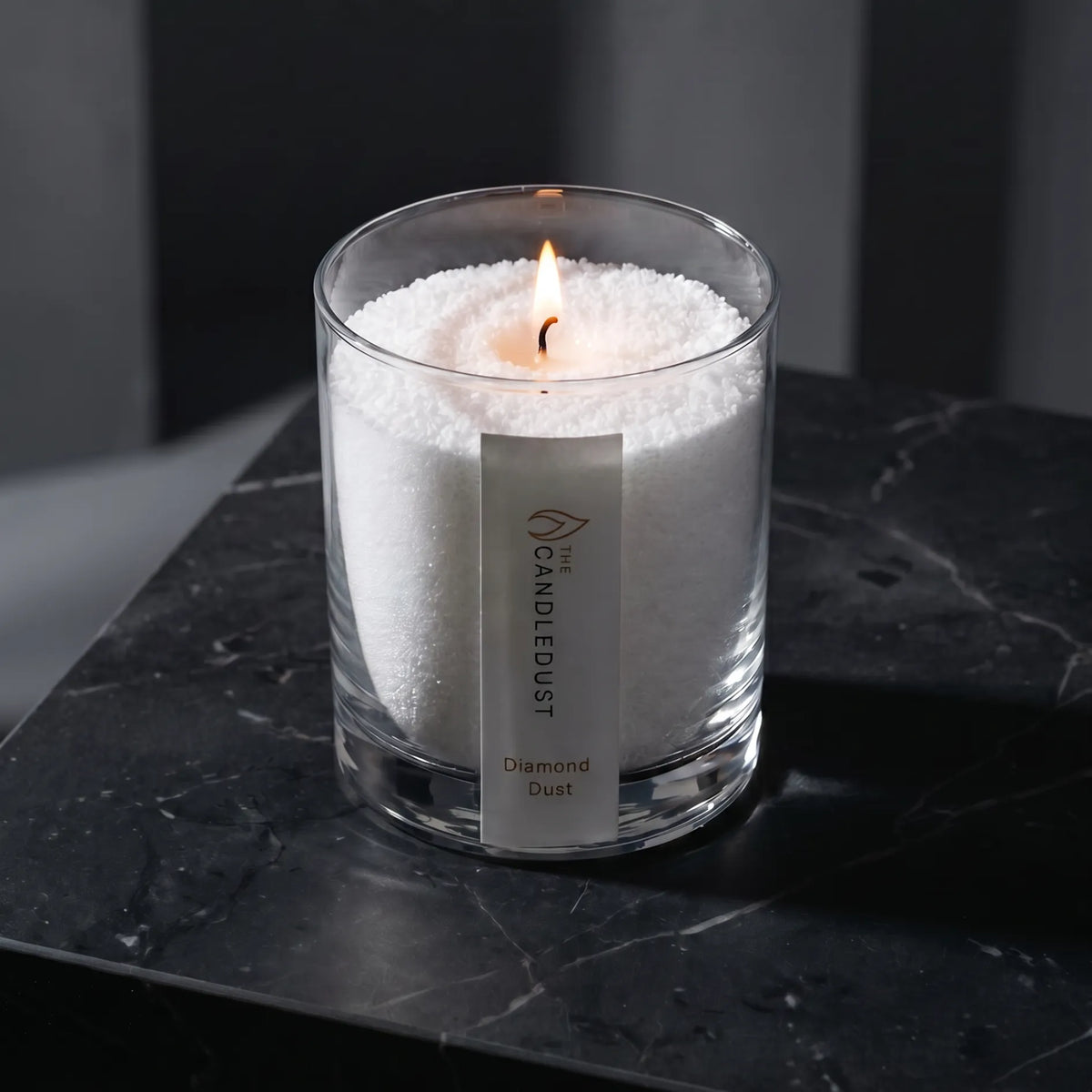 Modern minimalist interior styling featuring a lit Diamond Dust scented glass candle 