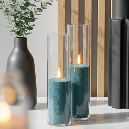 Elegant glass vases filled with burning Emerald pearled candle sand creating a glowing cluster