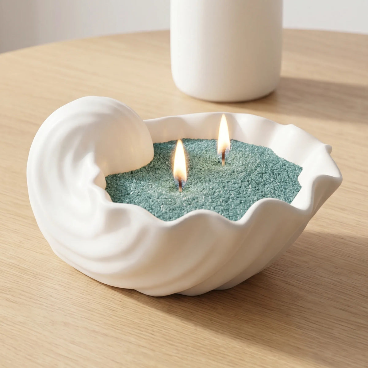 Elegant marble vase filled with Emerald pearled candle sand and lit cotton wicks resting on a wooden table