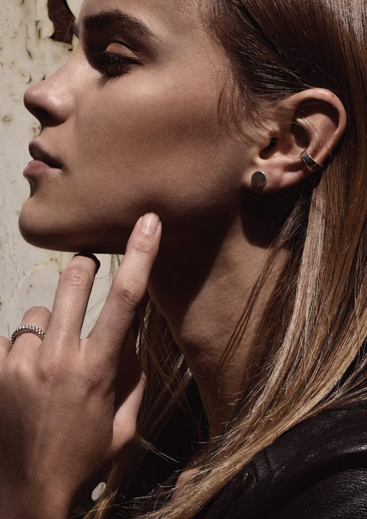 Close-up of a model's ear wearing the no-piercing silver Flat Upper Ear Cuff.