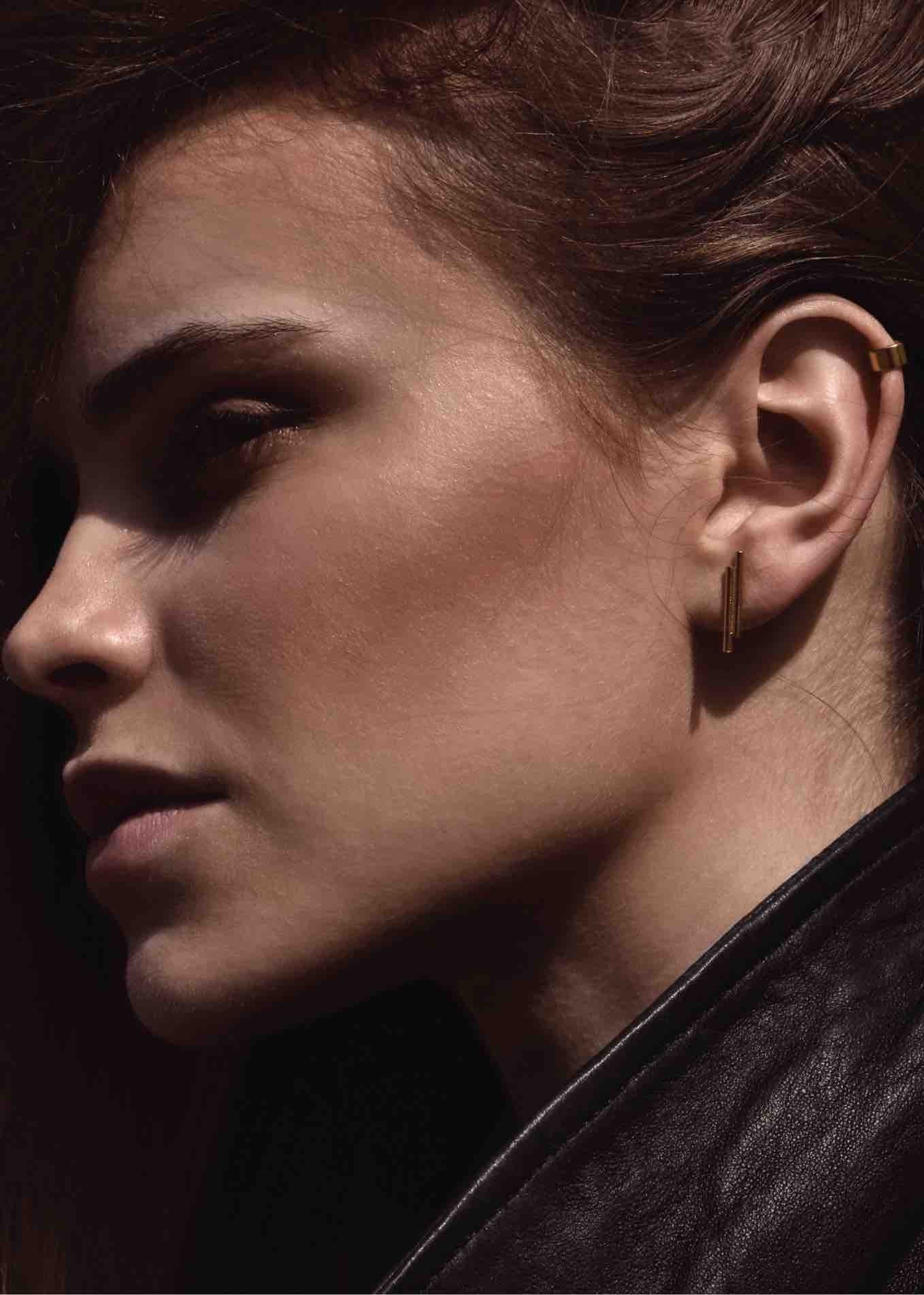 Side profile of a woman showcasing the gold Flat Upper Ear Cuff attached high.