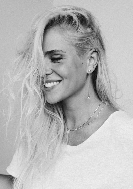 A stylish ear stack featuring the silver Flat Upper Ear Cuff paired with hoops.