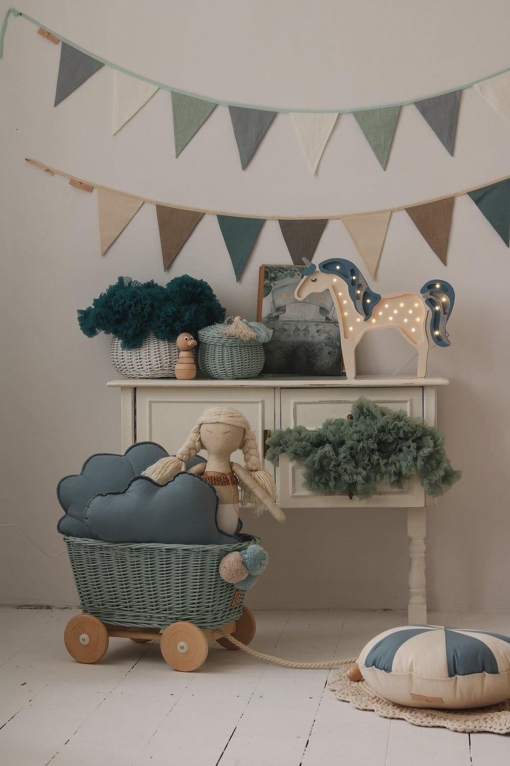 Nursery wall styling: Mint Love flags over a white wooden crib