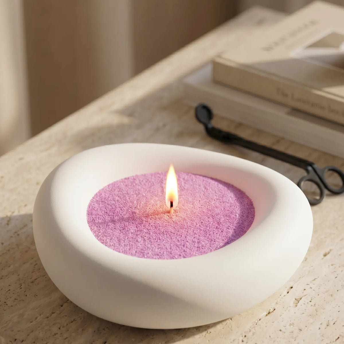 Close up of Elegant vase filled with Lilac pearled candle sand and lit cotton wicks resting on a refined countertop