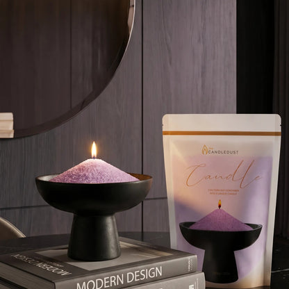 Lit Lilac pearled sand candle displayed on a decorative vase resting on stacked books
