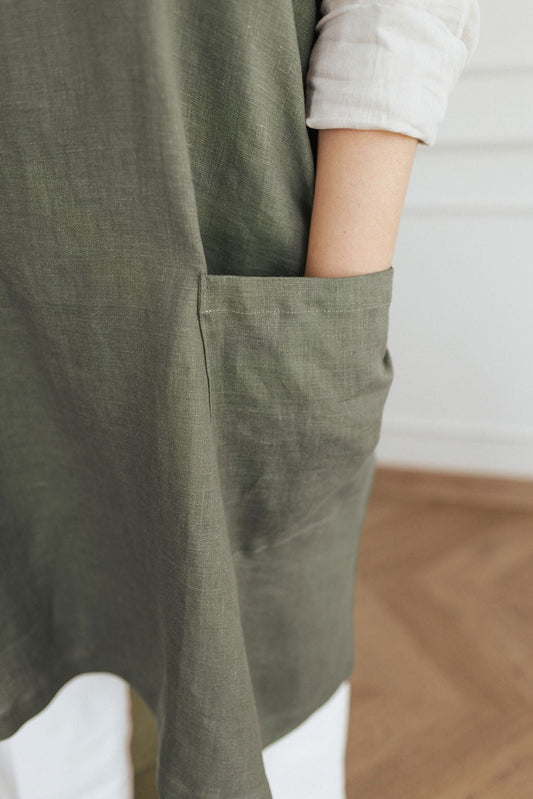 Cross Back Linen Apron Pocket detail in Green Olive - Front Model View \| NUSS |