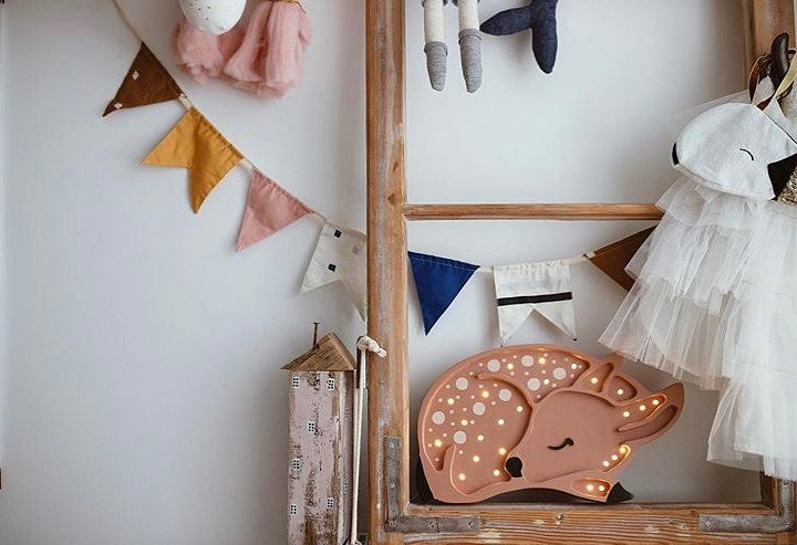 Decorative LED fawn lamp illuminating a child's room