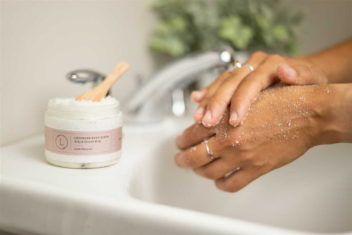 Lavender Body Scrub - Lifestyle shot of woman exfoliating her arm with natural bath scrub | Lizush