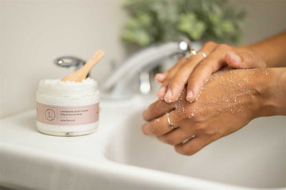 Lavender Body Scrub - Lifestyle shot of woman exfoliating her arm with natural bath scrub | Lizush