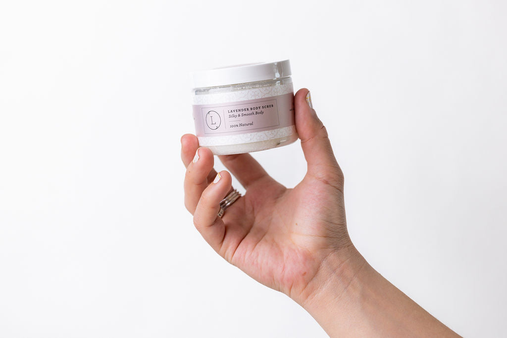 Lavender Body Scrub - Woman's hand holding jar of natural body scrub | Lizush