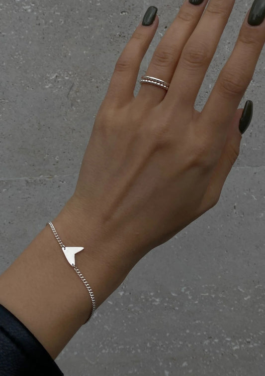 Lifestyle image of a woman elegantly styling the silver Love Bracelet.