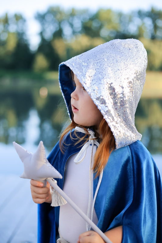 Moi Mili Snow Queen Magic Cape: a young girl in a velvet costume exploring a vast cornfield under a moody overcast sky