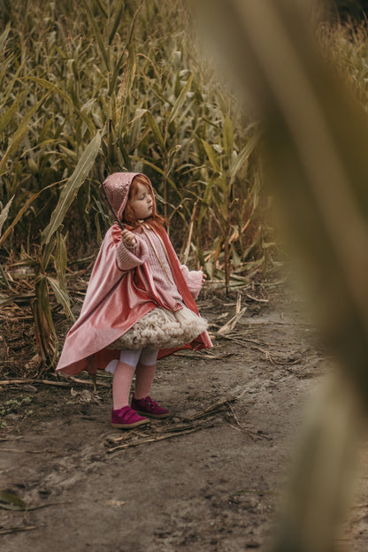 Moi Mili Magic Cape: a kid in a velvet costume exploring a vast cornfield under a moody overcast sky