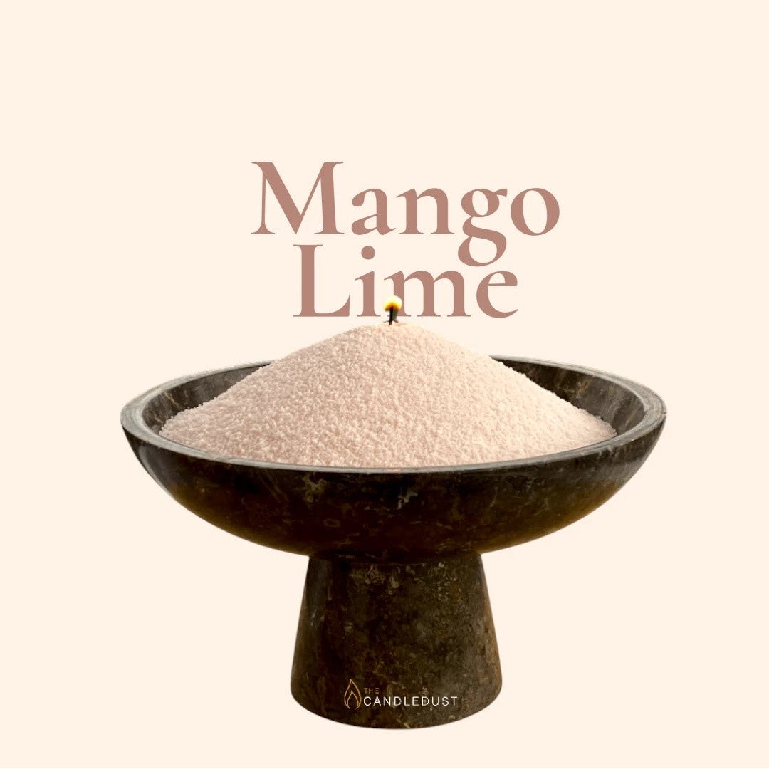 Mango Lime text on a matching vibrant tropical citrus background with a glass vase full of unlit pearled candle sand in the foreground