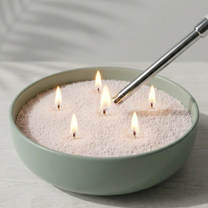 Close-up of hand lighting the cotton wick of a Mango Lime scented pearled sand candle