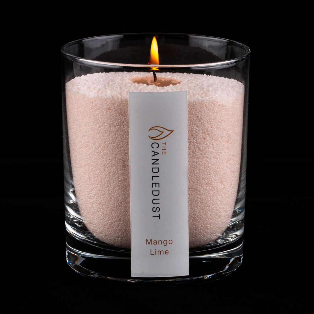 Lit Candledust Mango Lime scented pearled candle in a 160g glass jar on a black background