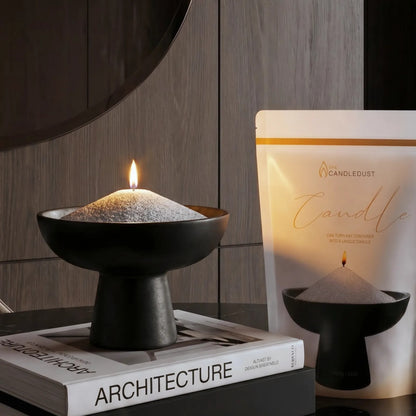 Lit Midnight scented pearled sand candle displayed on a decorative vase resting on stacked books