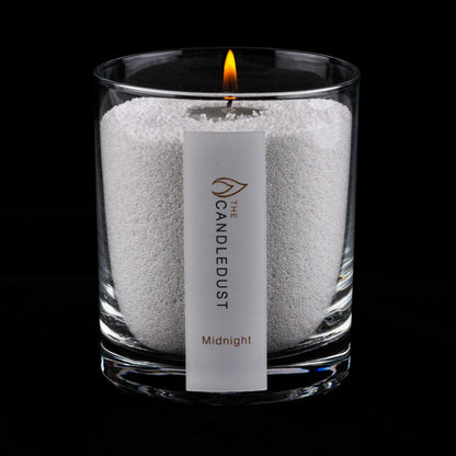 Lit Candledust Midnight scented pearled candle in a 160g glass jar on a black background