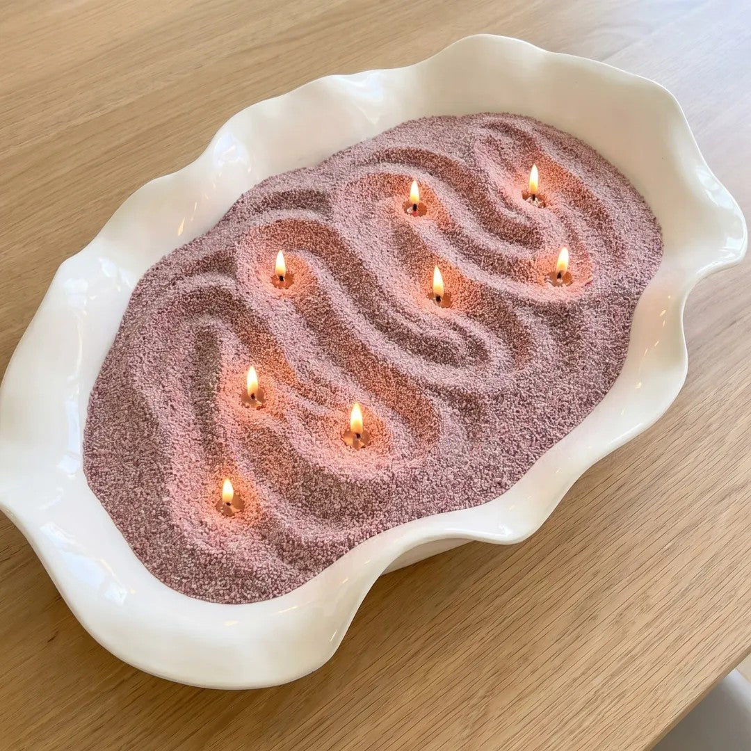 Large decorative tray filled with Mocha Mousse pearled candle sand and multiple lit cotton wicks burning cleanly