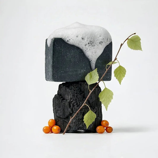 Foam of USVA Cosmetics Nordic Detox solid soap bar on a piece of coal