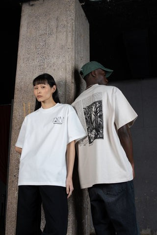 Lifestyle photo of Male and Female  model styled in the oversized Moomin Novels Heavy T-Shirt Comet White.