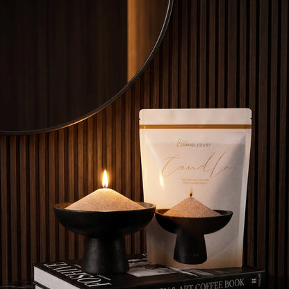 Lit Nude pearled sand candle displayed on a decorative vase resting on stacked books