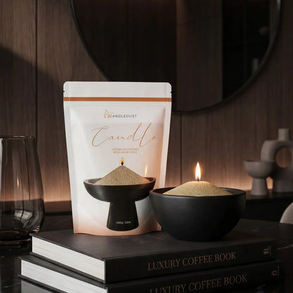 Lit Olive Green pearled sand candle displayed on a decorative vase resting on stacked books