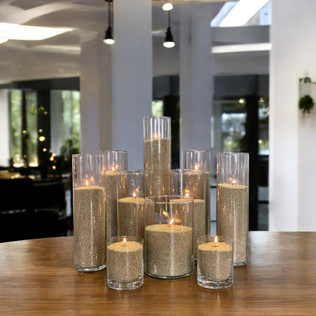 Glass vases of various heights filled with burning Olive Green pearled candle sand creating a glowing cluster