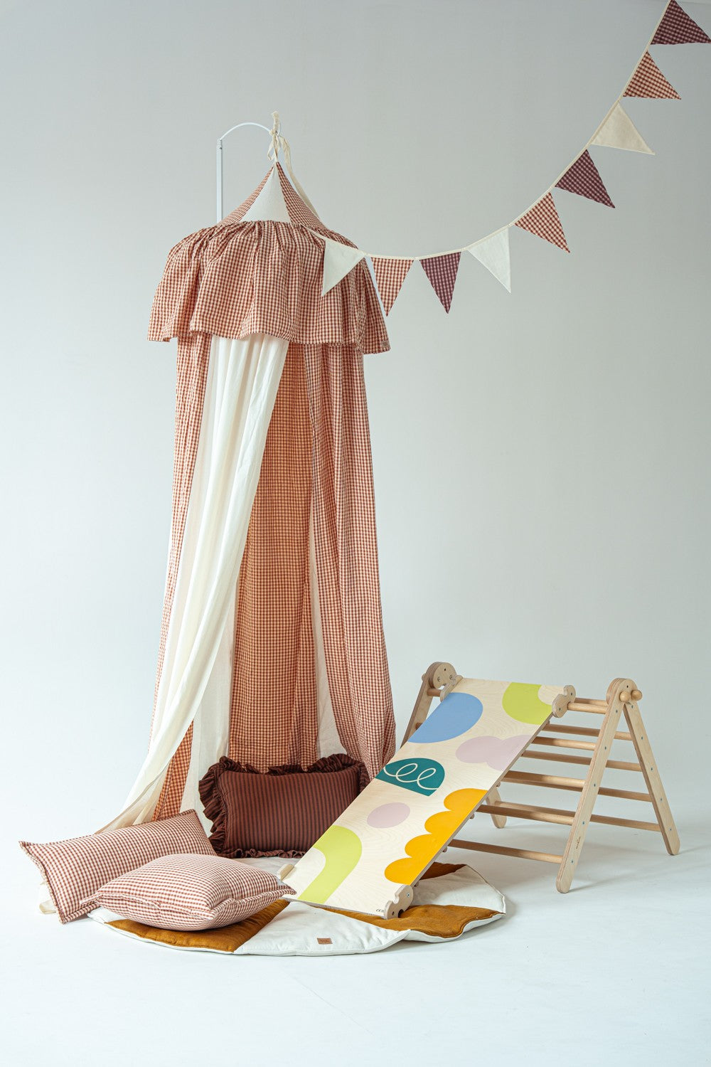 Kids playroom featuring a rust and white checkered circus canopy