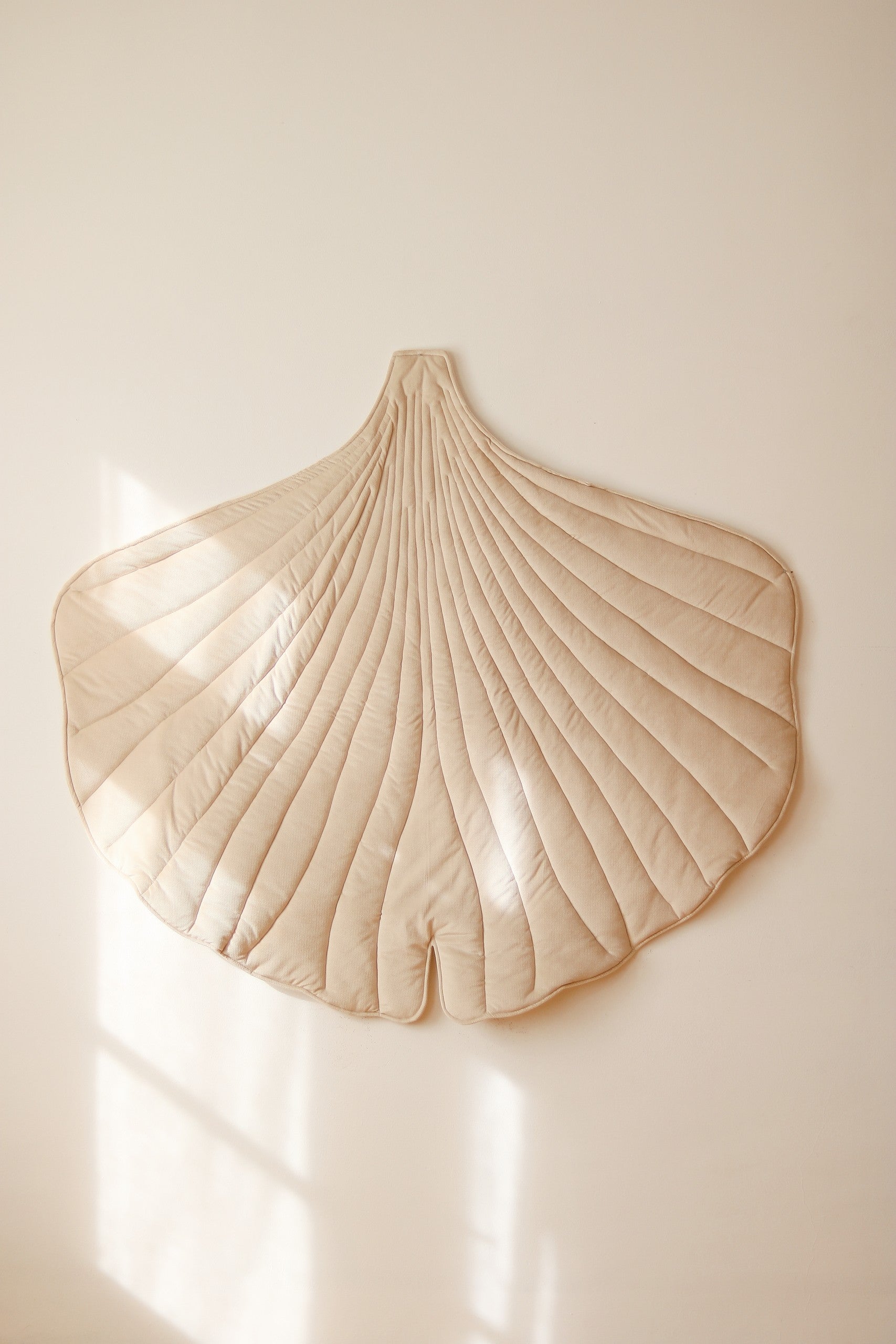 Premium velvet and organic cotton fabric texture of the Cream ginkgo playmat