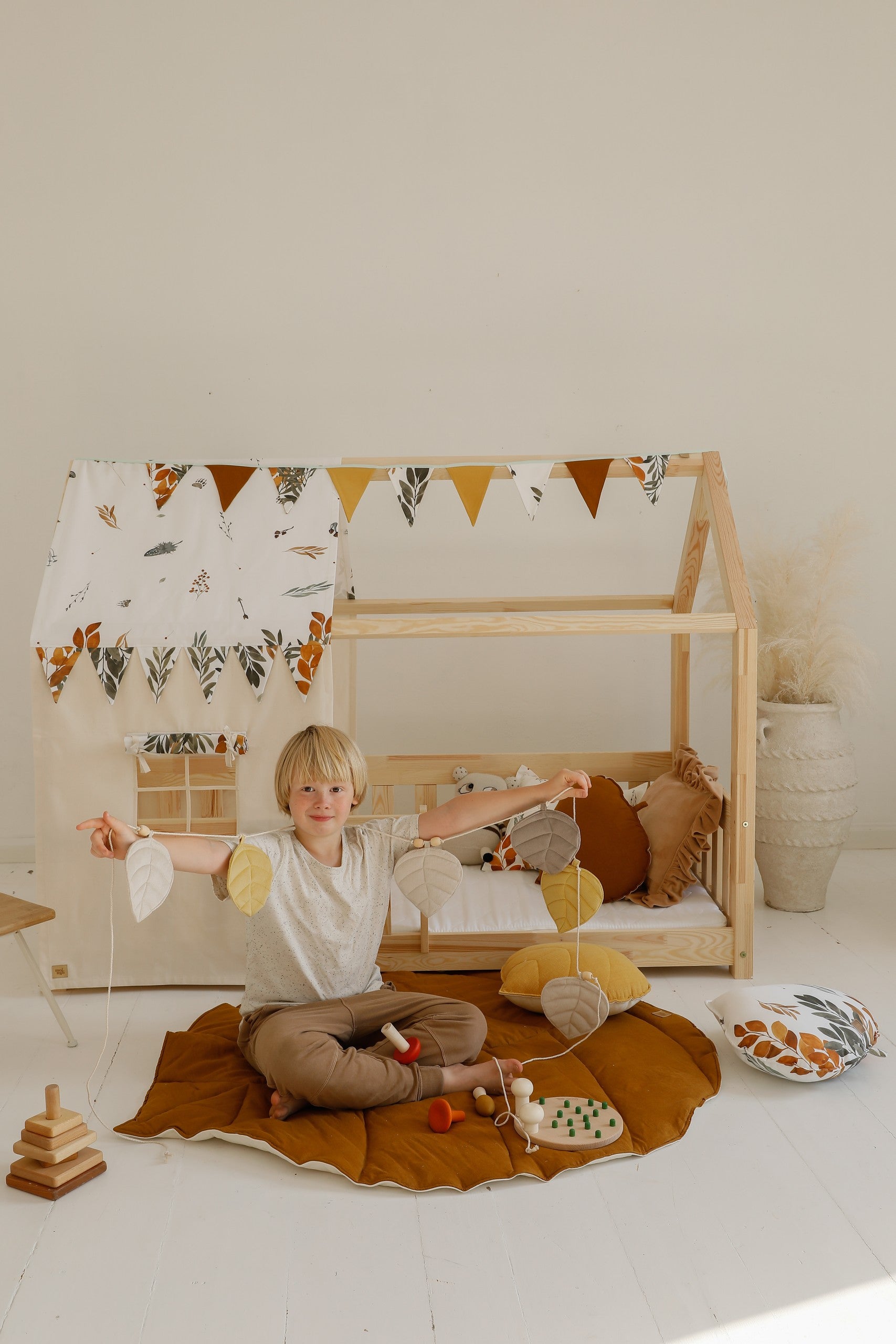 Nursery decor: Caramel linen leaf playmat styled in a cozy, nature-themed room