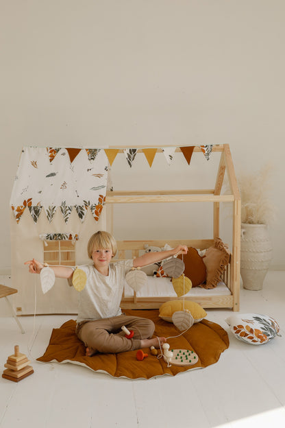Nursery decor: Caramel linen leaf playmat styled in a cozy, nature-themed room