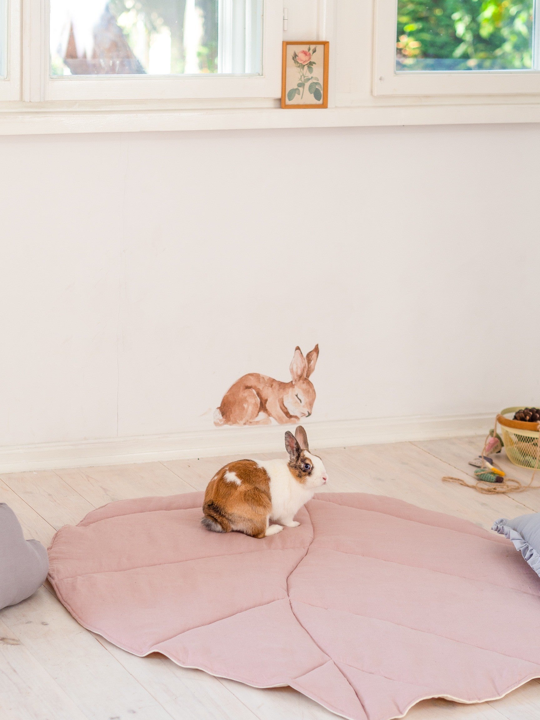 Moi Mili Powder Pink Leaf Playmat: a fluffy bunny rabbit resting on a soft quilted linen leaf-shaped baby mat